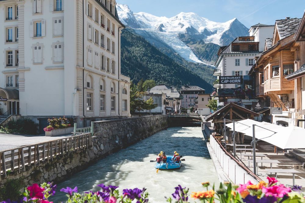 Rafting through downtown Chamonix with the mountain view in the background, France.