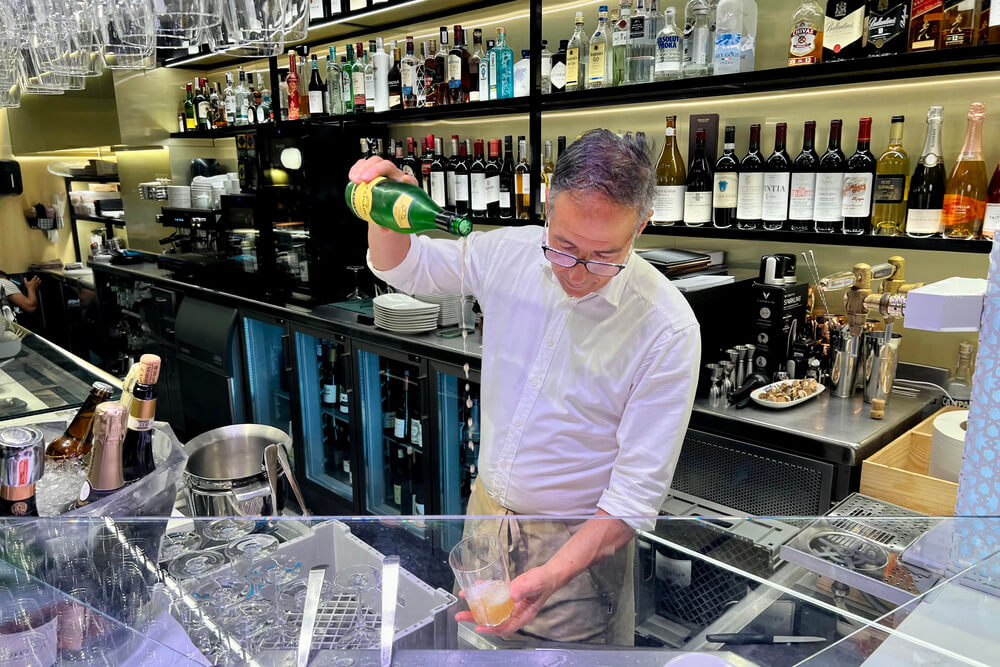 A bartender in pouring txakoli wine in San Sebastian, Spain.