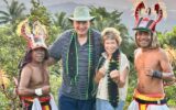 Christine Stoll and her husband with traditional whip dancers in Manggarai village, Indonesia.