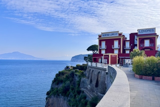Red hotel on a cliff in Sorrento, Italy.