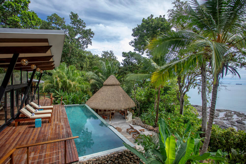 Exterior view of villa with a pool at Isla Palenque Resort in Panama.